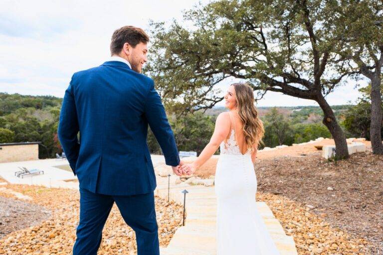 Bride and groom walking at Starlight Horizon wedding venue in Canyon Lake Texas