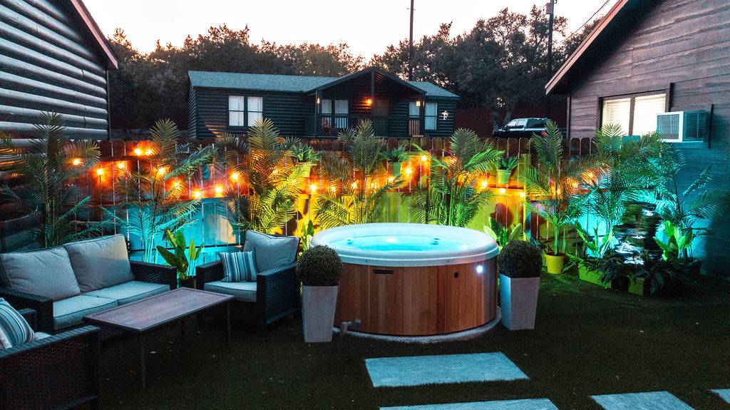 Hot tub under string lights at night at Starlight Horizon in Canyon Lake Texas