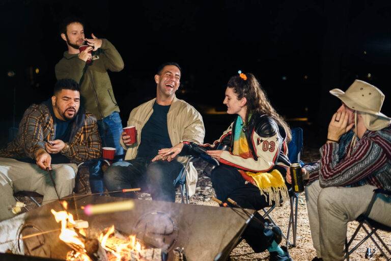 Friends around a fire pit at Starlight Horizon cabins in Canyon Lake Texas