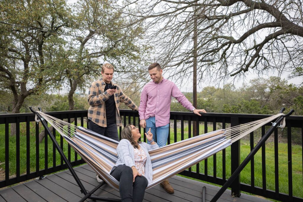 Friends on the Deck Hammock at Starlight Horizon, a boutique cabin resort near Canyon Lake, Texas