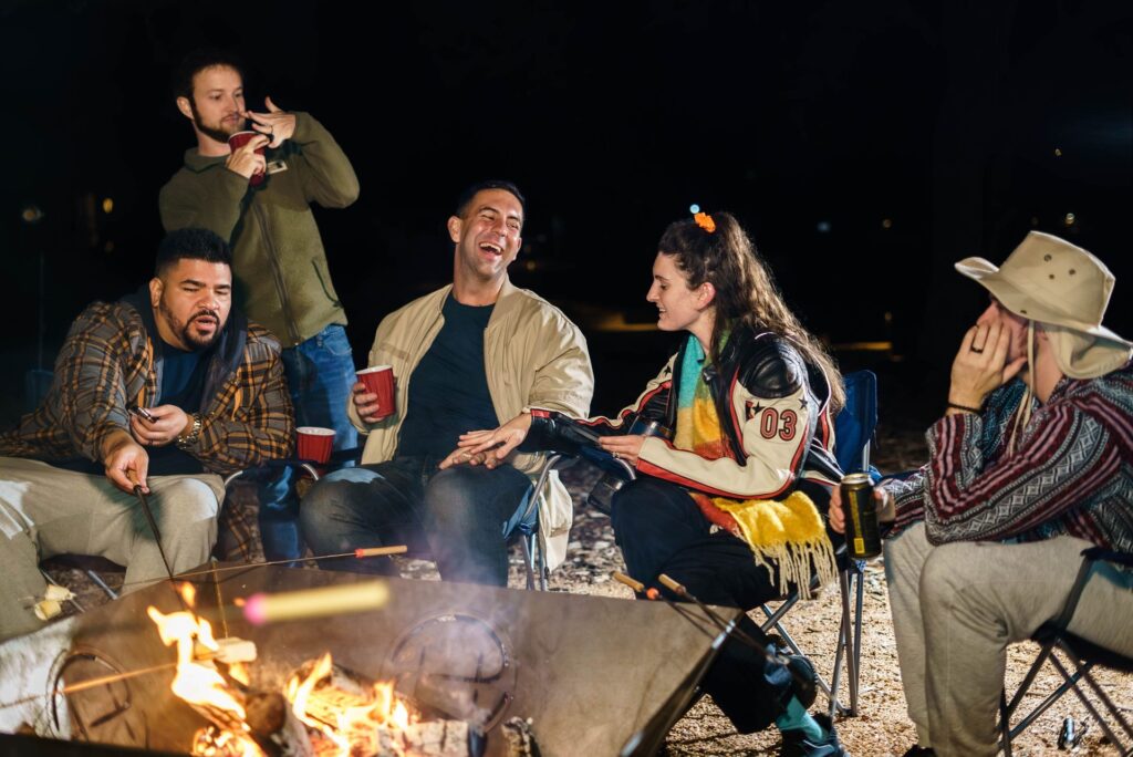 Friends Around the Firepit at Night at Starlight Horizon, a boutique cabin resort near Canyon Lake, Texas