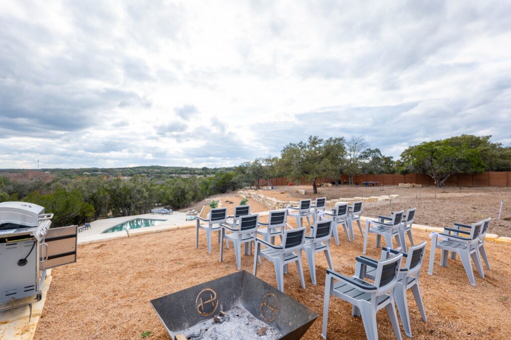 Poolside ceremony seating and firepit at Starlight Horizon, a boutique cabin resort near Canyon Lake, Texas
