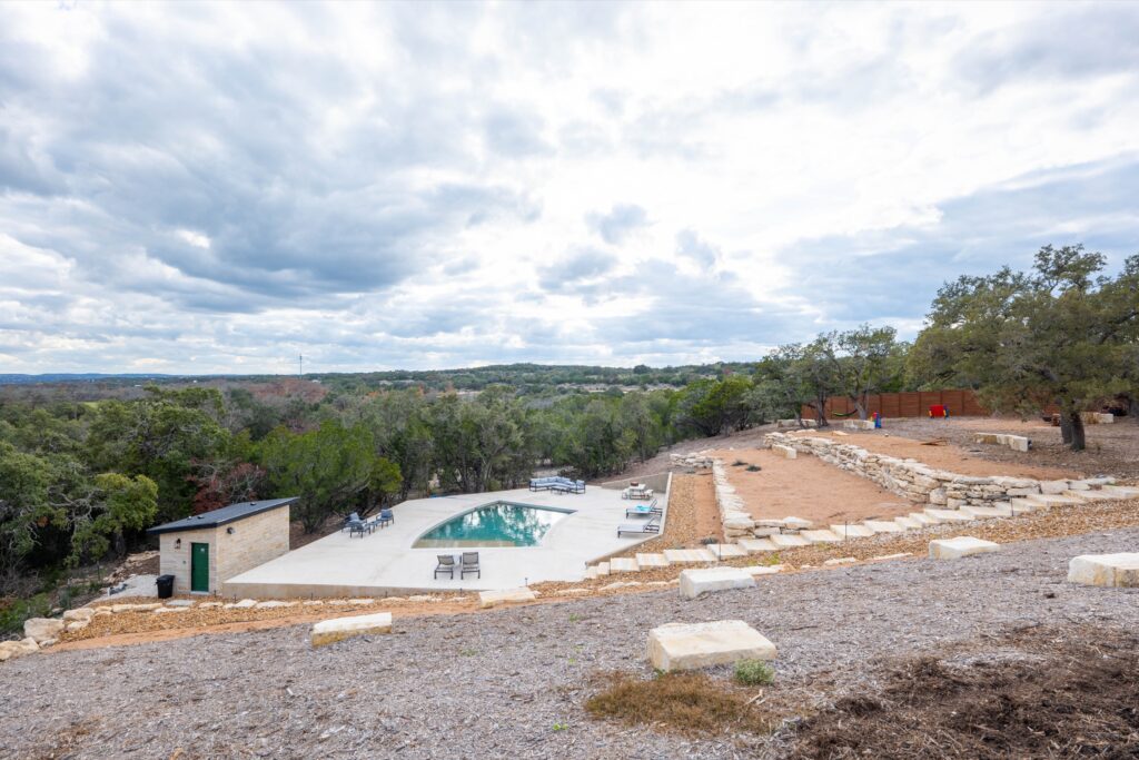 Elevated view of the pool and grounds at Starlight Horizon, a boutique cabin resort near Canyon Lake, Texas