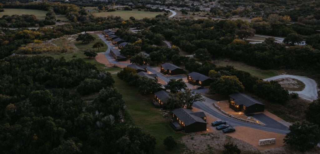 Aerial dusk view of the Starlight Horizon cabin row with lights on