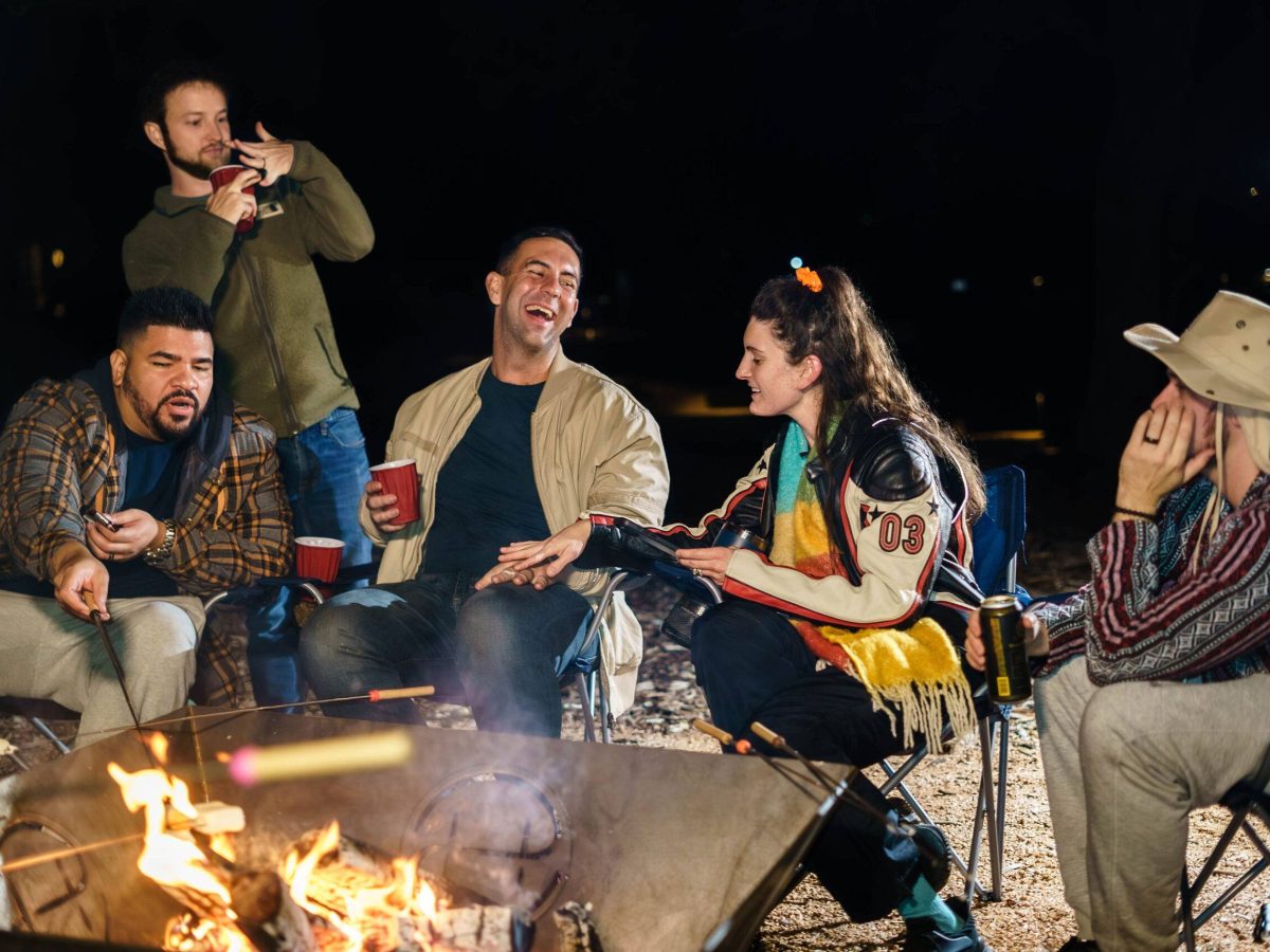 Friends around a fire pit at Starlight Horizon cabins in Canyon Lake Texas