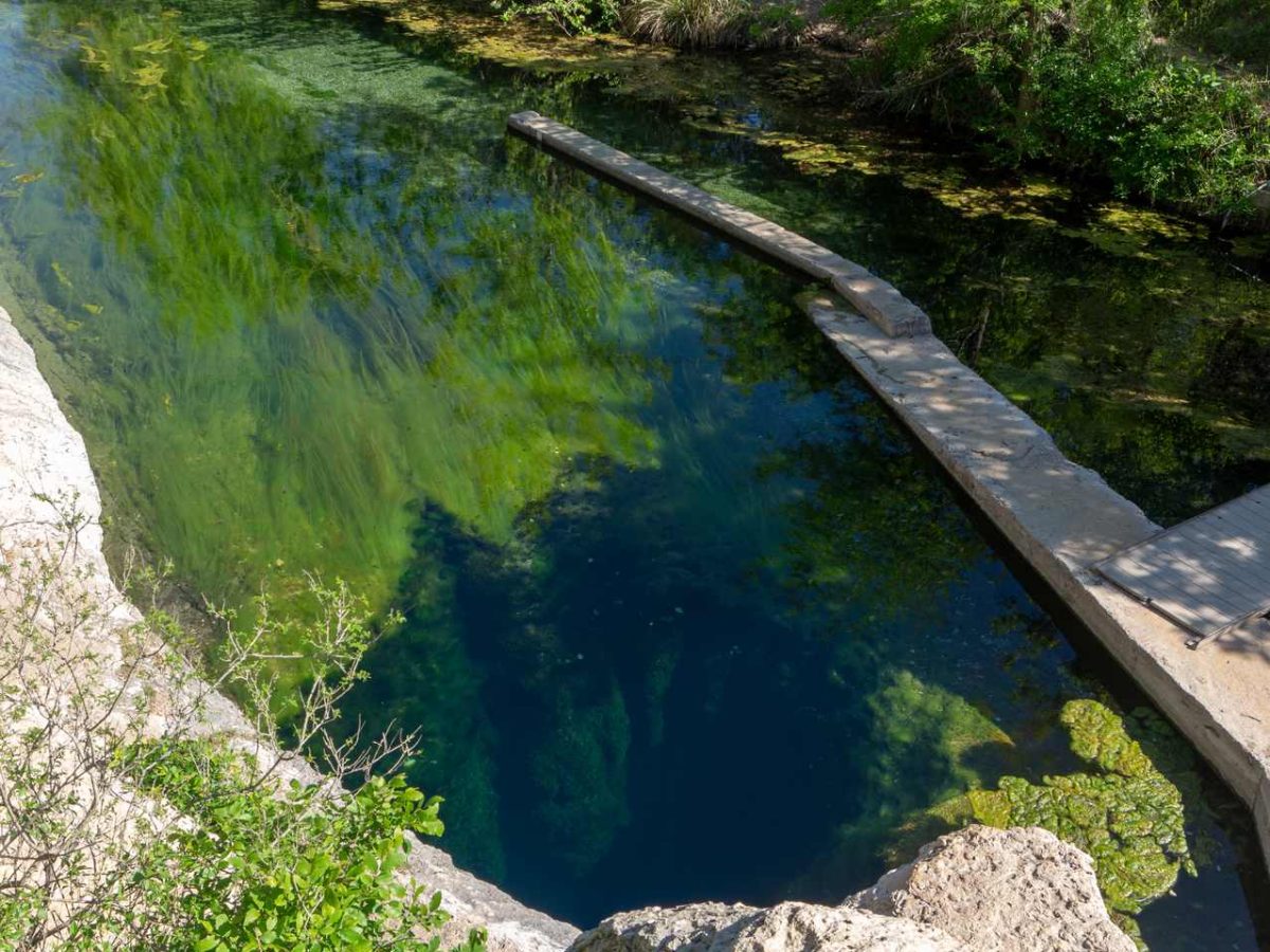 Jacob's Well natural spring near Wimberley, Texas, elevated view showing the deep blue water