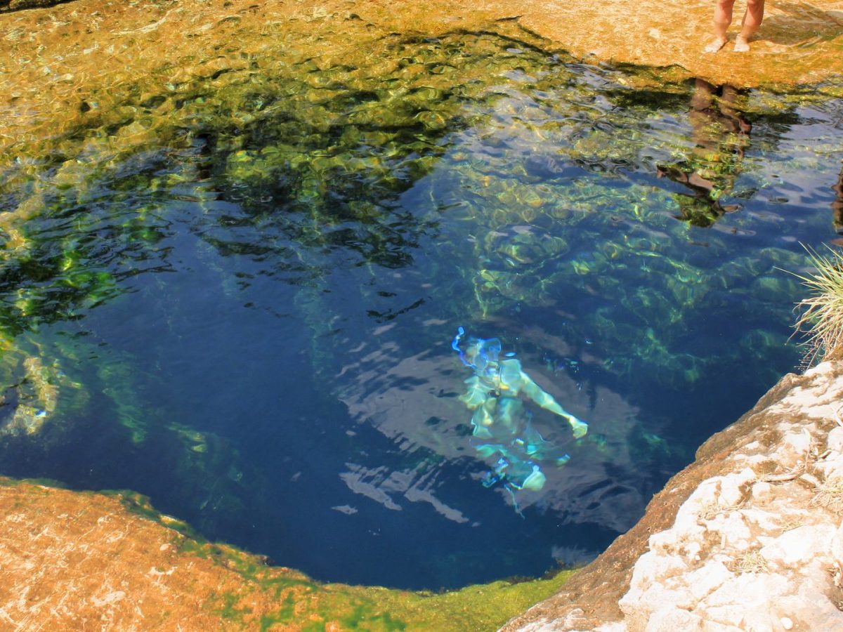 Swimmers at Jacob's Well natural spring near Wimberley, Texas