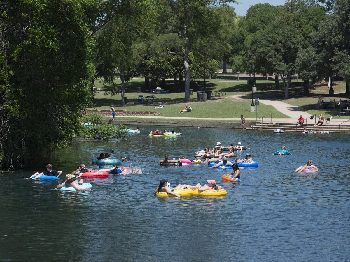 Crowd of tubers floating the Comal River at Prince Solms Park in New Braunfels Texas